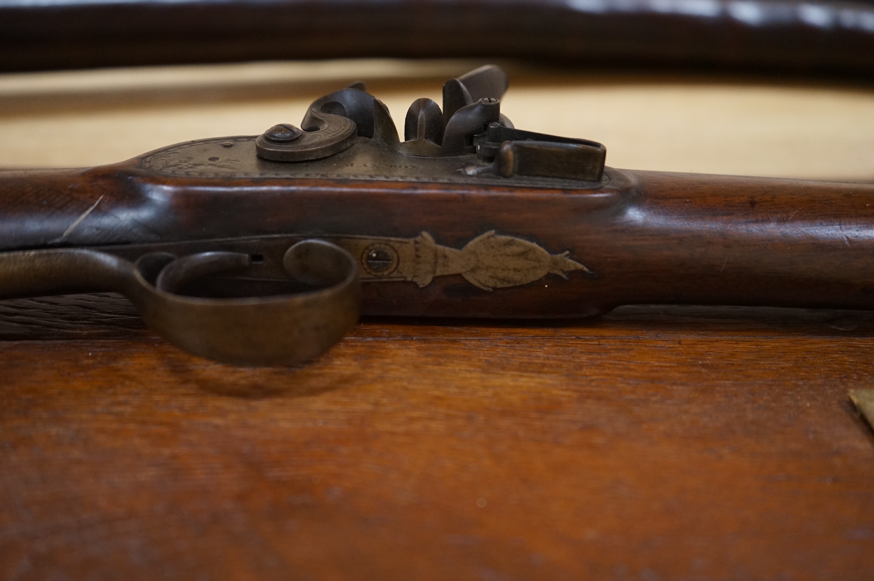 A single barrel flintlock sporting gun by Manton, half stocked, with signed lock and rainproof pan, platinum lined vent, and iron furniture (worn smooth)